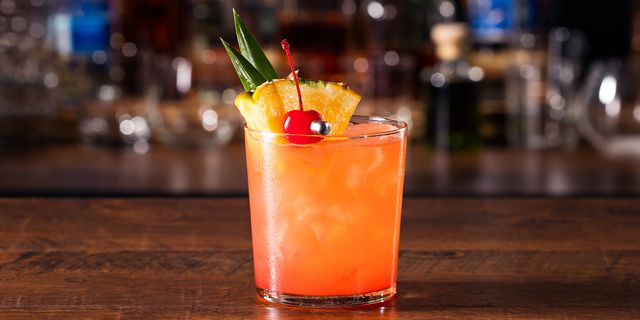 Close-up of a Mai Tai cocktail on a wooden countertop.